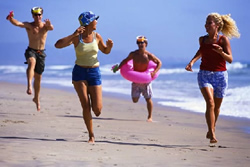 boys chasing girls on the beach