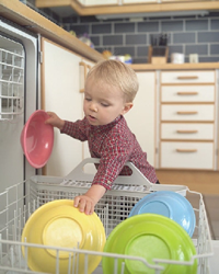 toddler washing dishes