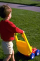 toddler pushing play mower