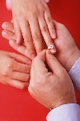 man placing a ring on a woman's hand